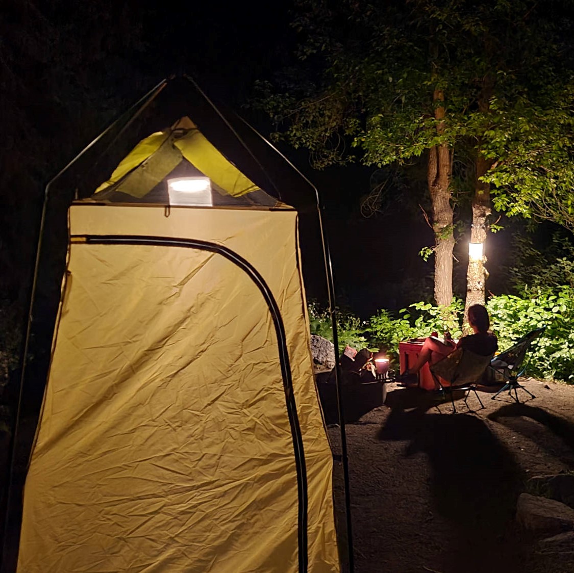 Night camping with solar laterns and a camping shower toilet combo - HelloTrail