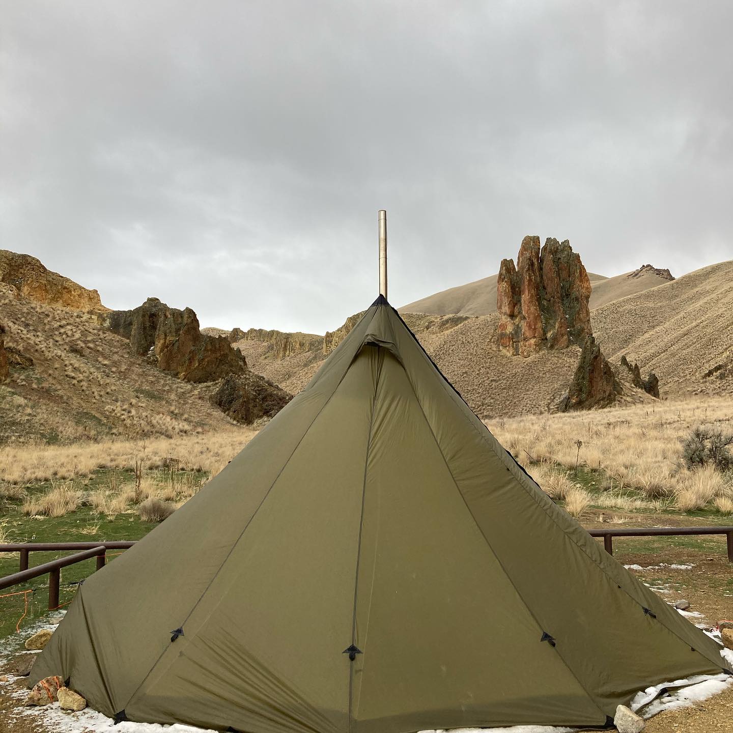 A canvas camping tent with stove port to stay warm in a tent without electricity - HelloTrail.comwarm