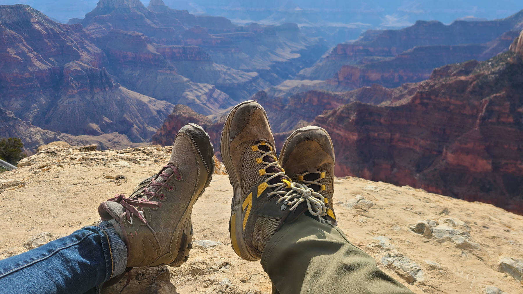 Ashley and Andrew's hiking boots with a view of the Grand Canyon in the background