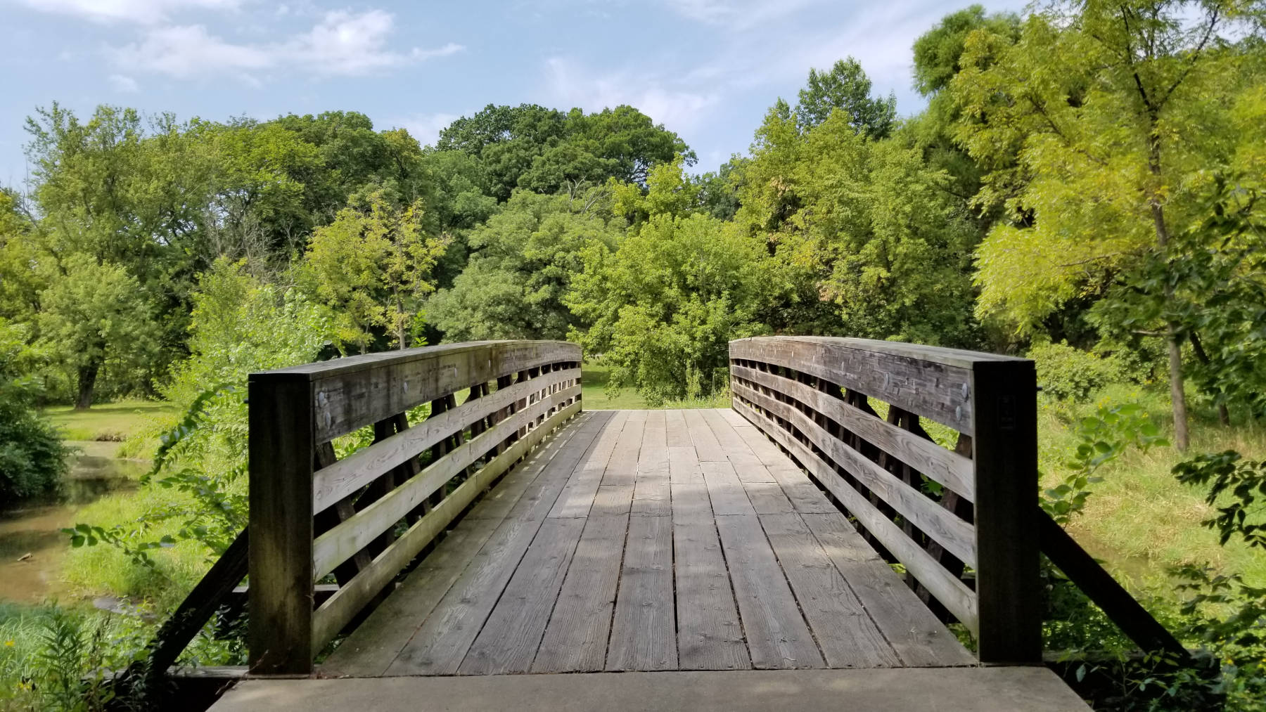 Hiking across a bridge in a scenic Illinois park