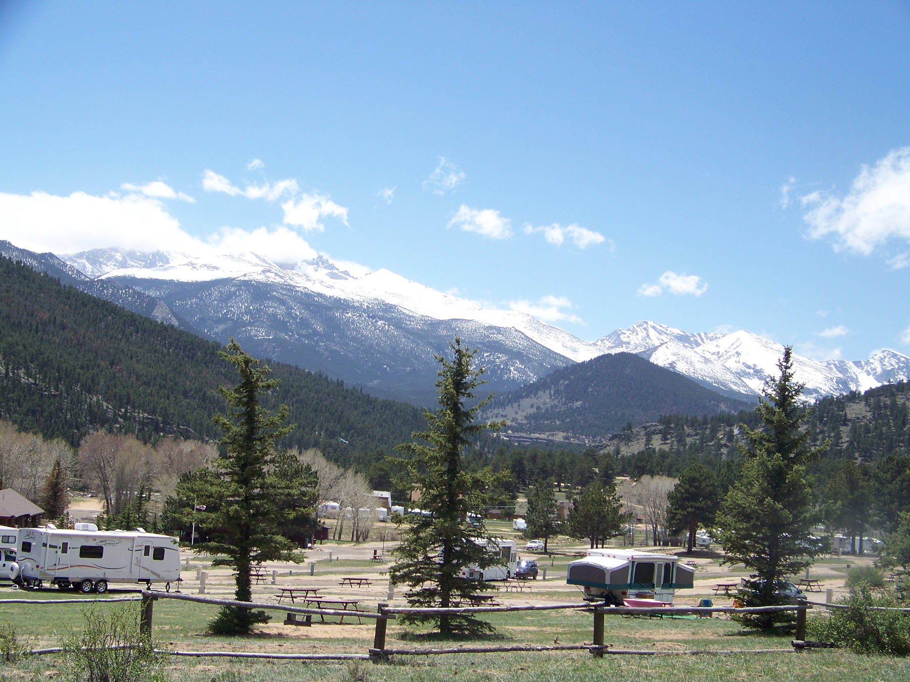 Snow capped mountain peaks in Rocky Mountain National Park viewed from an RV resort near Estes Park CO
