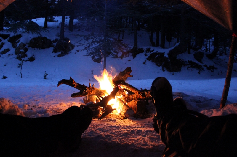 Winter camping with a campfire