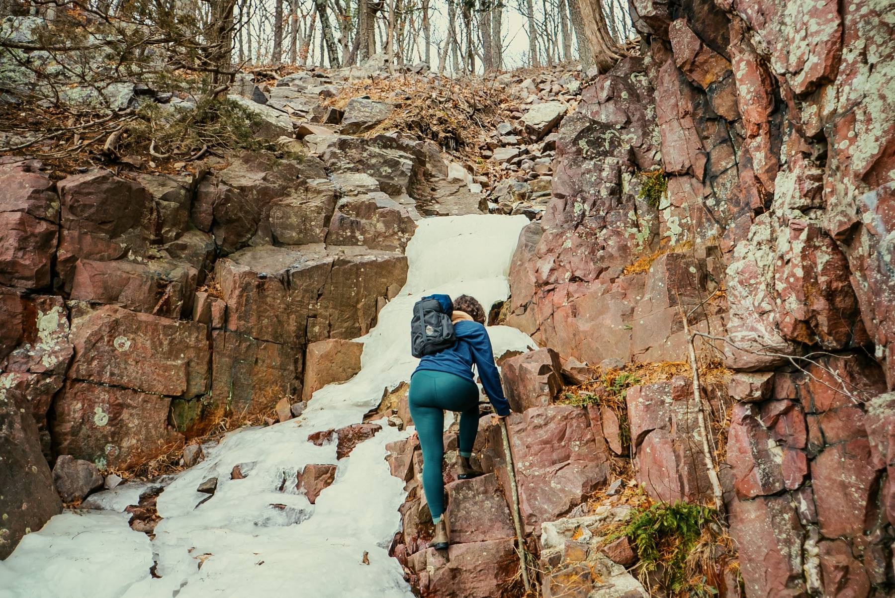 Hiking pants can even withstand scrambling up rocks near a frozen waterfall